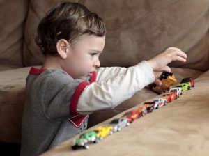 autistic child arranging his toys in an order