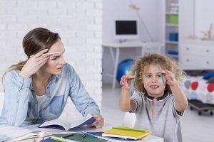 child playing with pencil lacking social behaviour